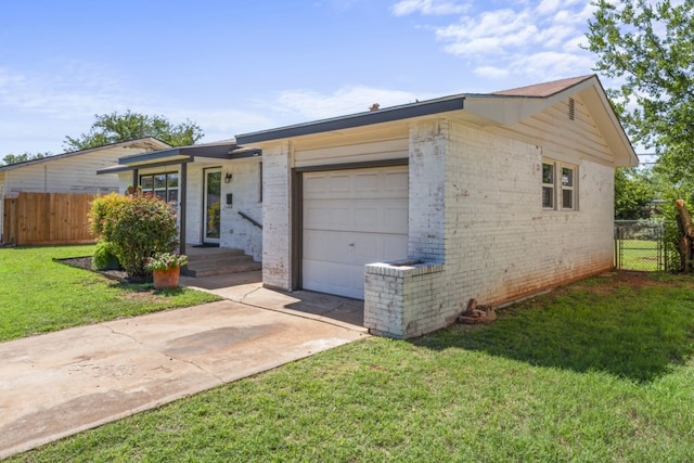 ranch-style home featuring a garage and a front yard