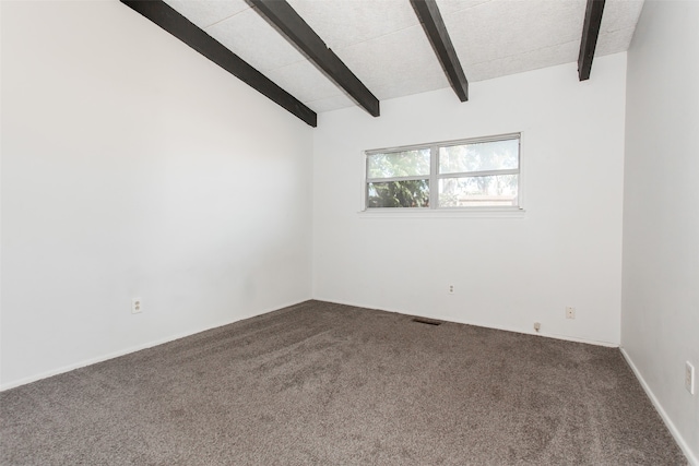 carpeted empty room featuring lofted ceiling with beams