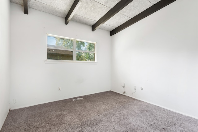 carpeted empty room featuring lofted ceiling with beams