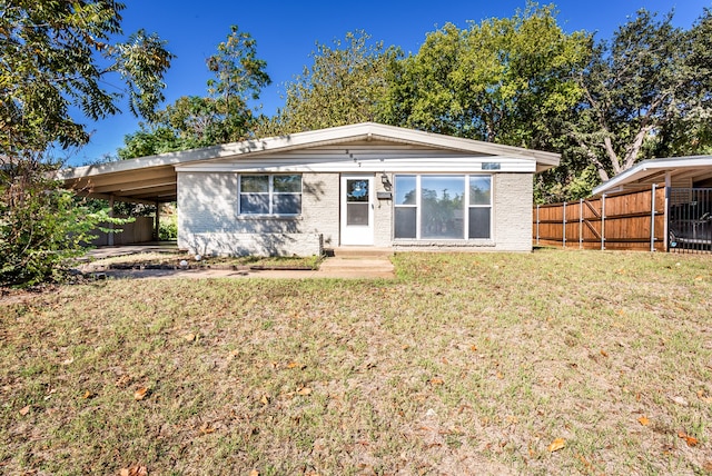 view of front of property with a front lawn and a carport