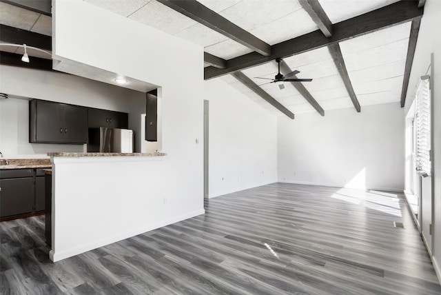 unfurnished living room featuring beamed ceiling, sink, ceiling fan, dark hardwood / wood-style floors, and high vaulted ceiling