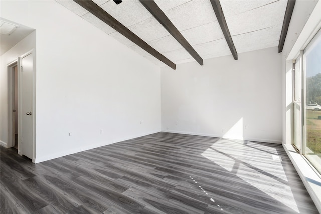 unfurnished living room with dark wood-type flooring, lofted ceiling with beams, and a healthy amount of sunlight