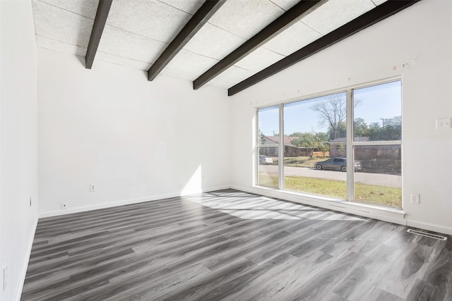 unfurnished room with lofted ceiling with beams, dark wood-type flooring, and a wealth of natural light