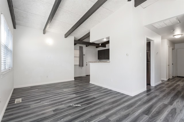 unfurnished living room with dark wood-type flooring and lofted ceiling with beams