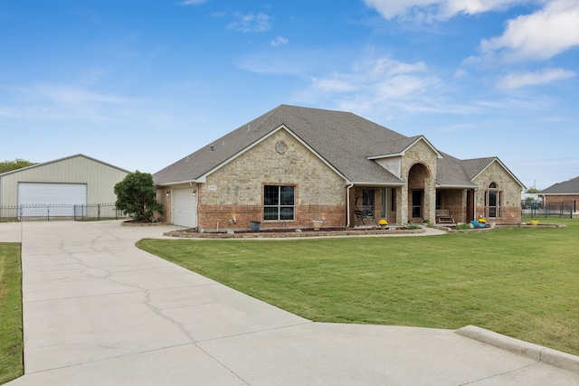 view of front of house featuring a porch, a front yard, and a garage