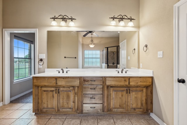 bathroom featuring a shower with door, vanity, tile patterned flooring, and ceiling fan