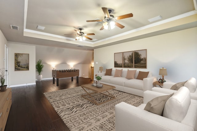 living room featuring crown molding, dark hardwood / wood-style floors, ceiling fan, and a tray ceiling