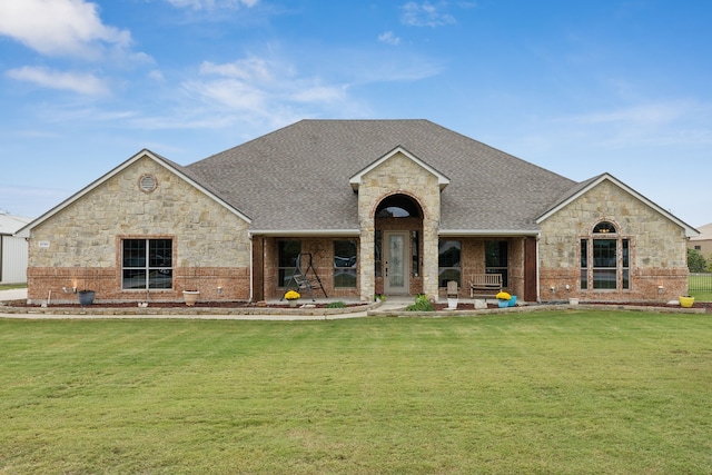 2741 Purple Sage Trl, Fort Worth, TX 76179 - view of front facade with stone siding, a shingled roof, a front yard, and brick siding