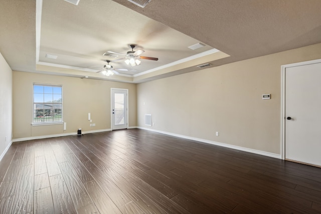 spare room featuring a textured ceiling, dark hardwood / wood-style floors, a raised ceiling, and ceiling fan