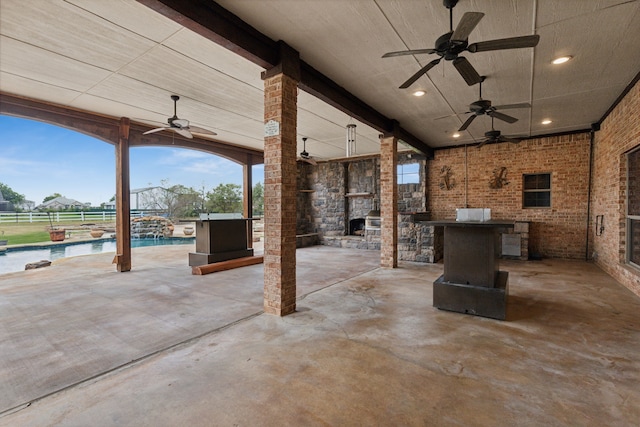 view of patio / terrace with ceiling fan, a fenced in pool, and pool water feature