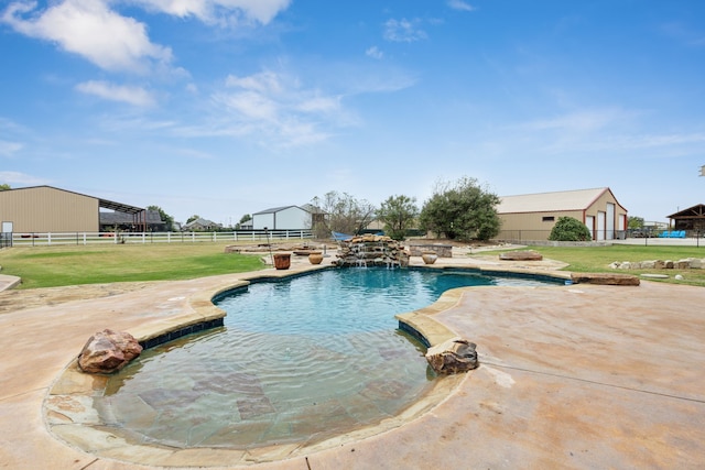 view of pool featuring a patio and a yard