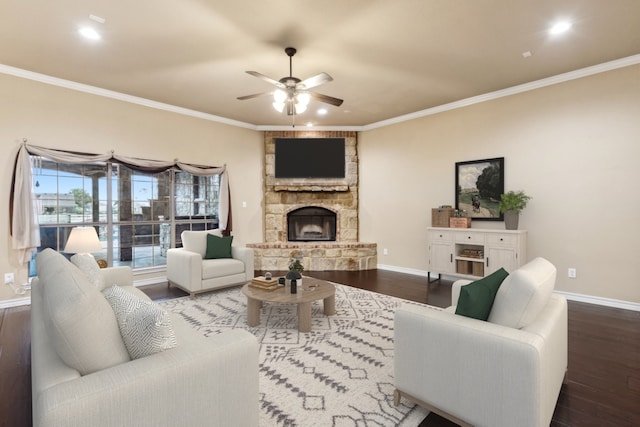 living room with dark wood-type flooring, crown molding, and a fireplace