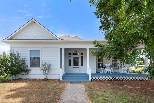 view of front of property featuring covered porch and a front yard