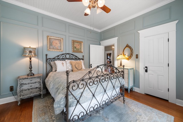 bedroom featuring hardwood / wood-style floors, ceiling fan, and crown molding