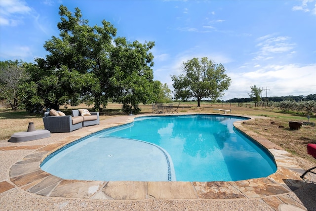 view of swimming pool featuring a diving board and a patio