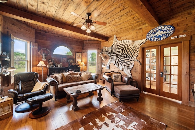 interior space featuring beamed ceiling, a wealth of natural light, and french doors