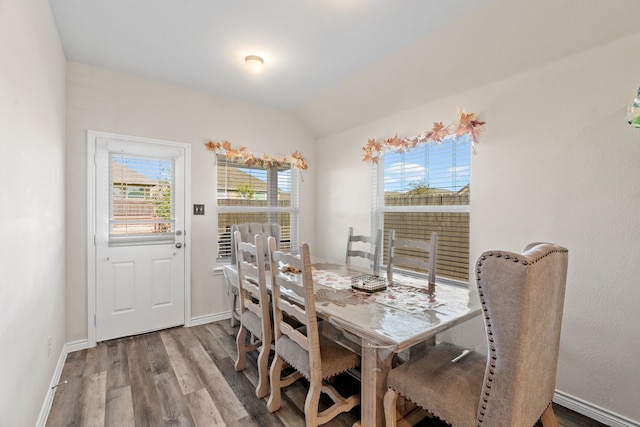 dining area with hardwood / wood-style floors and lofted ceiling