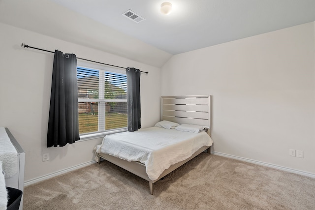 carpeted bedroom with vaulted ceiling