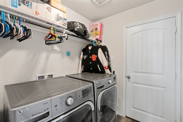 washroom featuring hardwood / wood-style flooring and independent washer and dryer