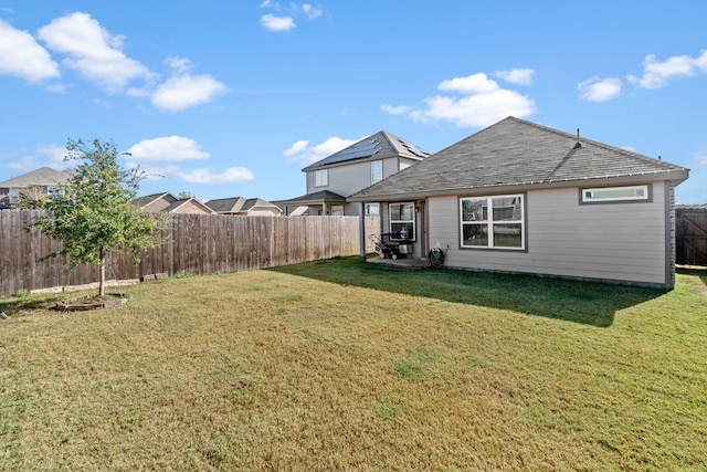 rear view of property featuring a yard