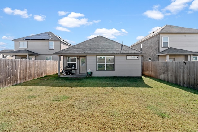 rear view of house with a yard