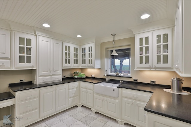 kitchen with hanging light fixtures, sink, and white cabinets