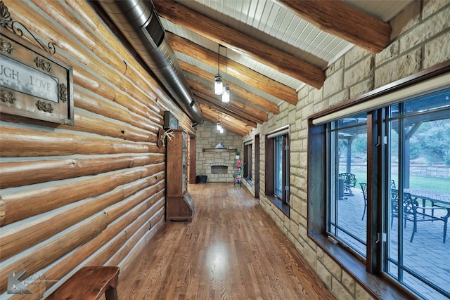 hall featuring hardwood / wood-style flooring, vaulted ceiling with beams, log walls, and wooden ceiling