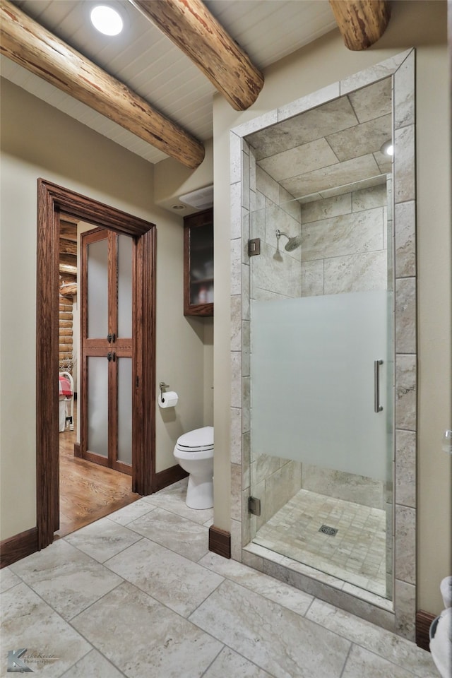 bathroom featuring walk in shower, toilet, and beam ceiling