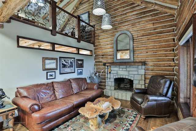 living room featuring wood-type flooring, high vaulted ceiling, beam ceiling, a fireplace, and log walls