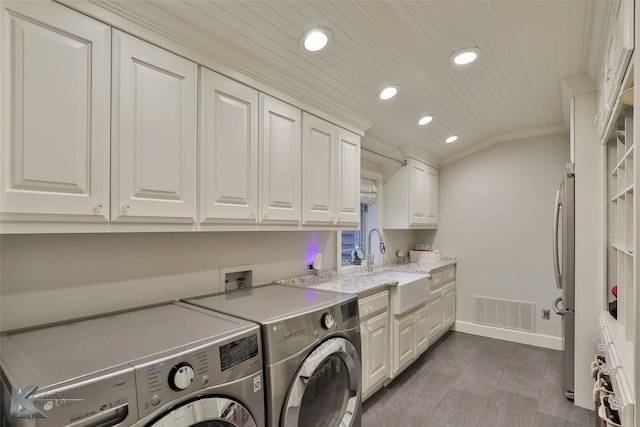 washroom with cabinets, wooden ceiling, sink, crown molding, and washing machine and dryer