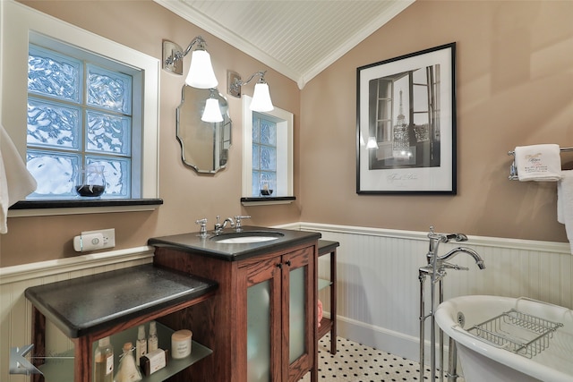 bathroom featuring ornamental molding, lofted ceiling, and vanity