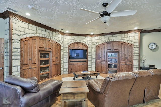 living room with ceiling fan, ornamental molding, and light hardwood / wood-style flooring