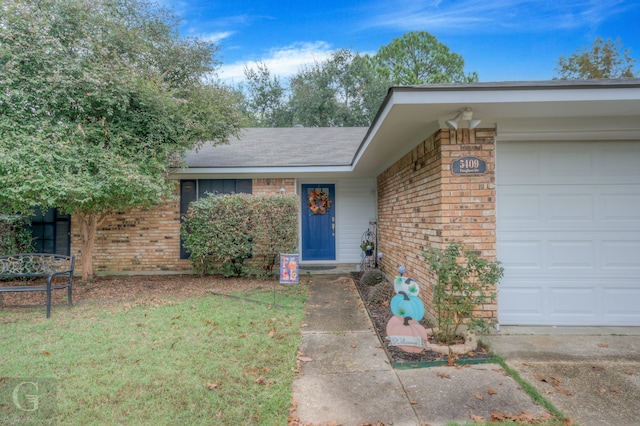 ranch-style house with a garage and a front lawn