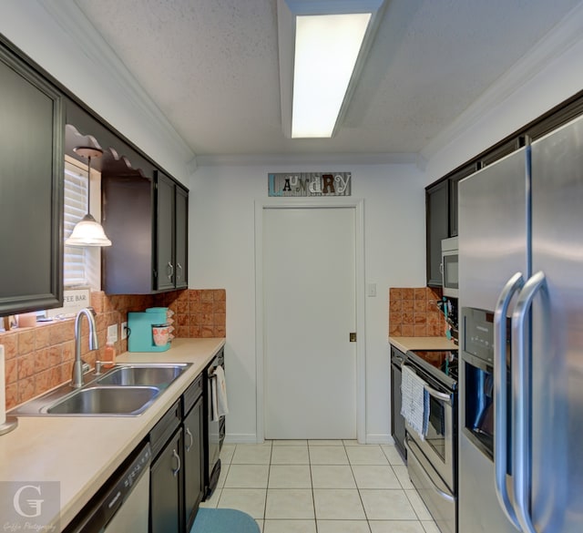 kitchen featuring light tile patterned flooring, crown molding, appliances with stainless steel finishes, sink, and decorative backsplash