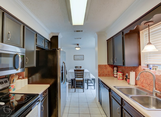 kitchen with stainless steel appliances, sink, crown molding, backsplash, and pendant lighting