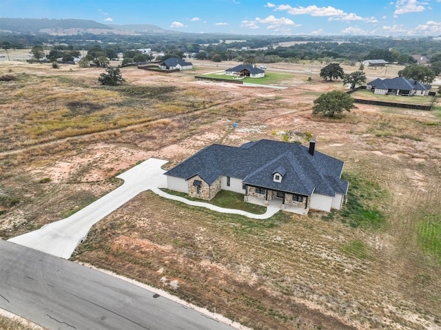 birds eye view of property featuring a mountain view and a rural view