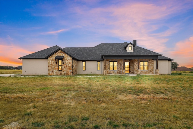 view of front facade featuring a patio area and a lawn