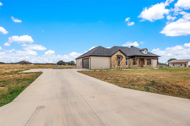 view of front of home with a garage and a front lawn