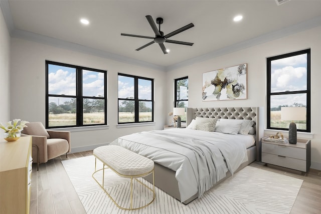 bedroom featuring ceiling fan, light hardwood / wood-style floors, and crown molding