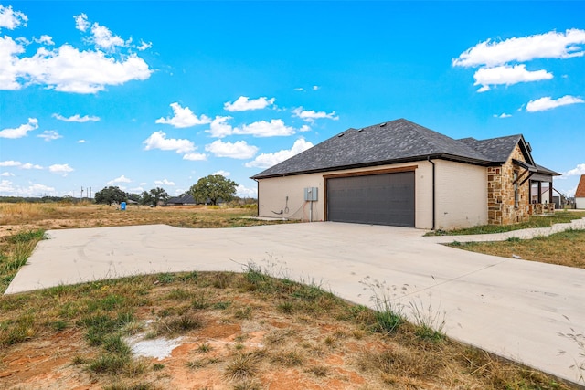 view of side of home featuring a garage