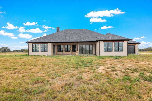 rear view of property with a yard