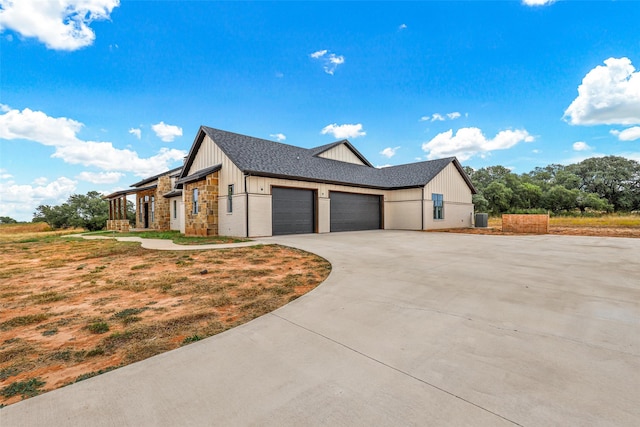 view of side of home featuring a garage and cooling unit