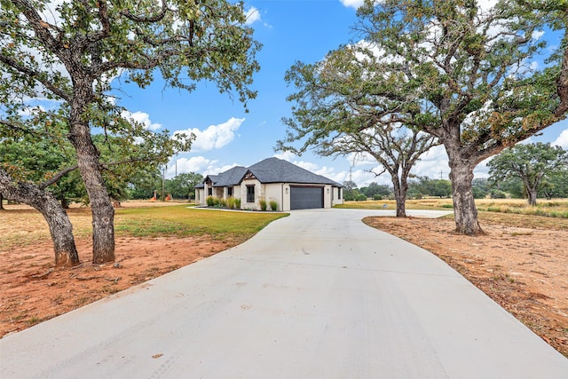 view of front of house with a garage and a front yard