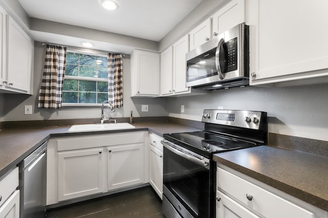 kitchen featuring stainless steel appliances, white cabinets, and sink