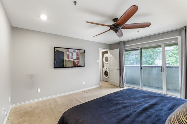 bedroom with stacked washing maching and dryer, access to exterior, light colored carpet, and ceiling fan