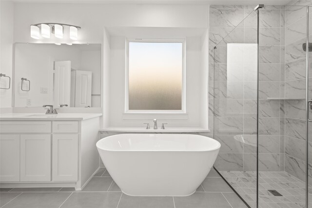 bathroom featuring shower with separate bathtub, vanity, and tile patterned floors