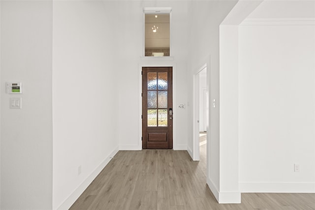 entryway featuring light hardwood / wood-style flooring and ornamental molding