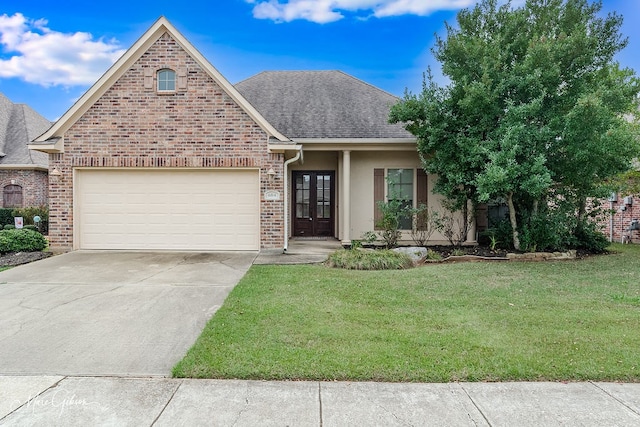 view of front of home featuring a front lawn, a garage, and french doors