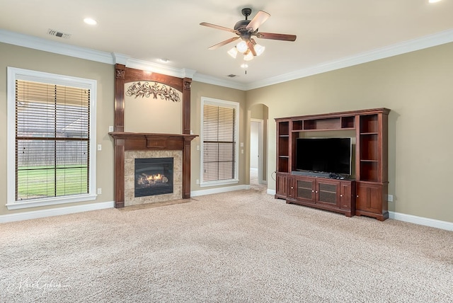 unfurnished living room featuring a tiled fireplace, light carpet, and ceiling fan