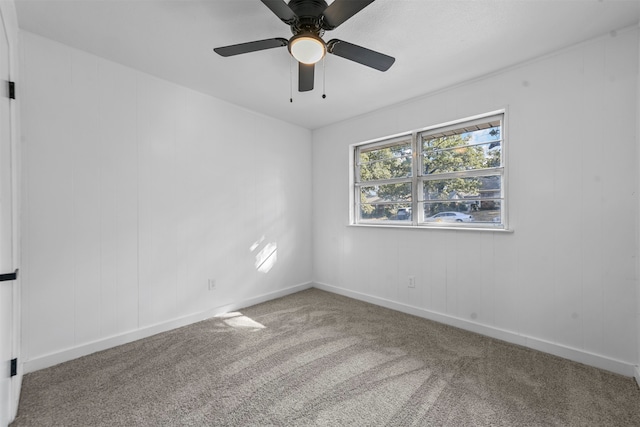 carpeted empty room featuring ceiling fan